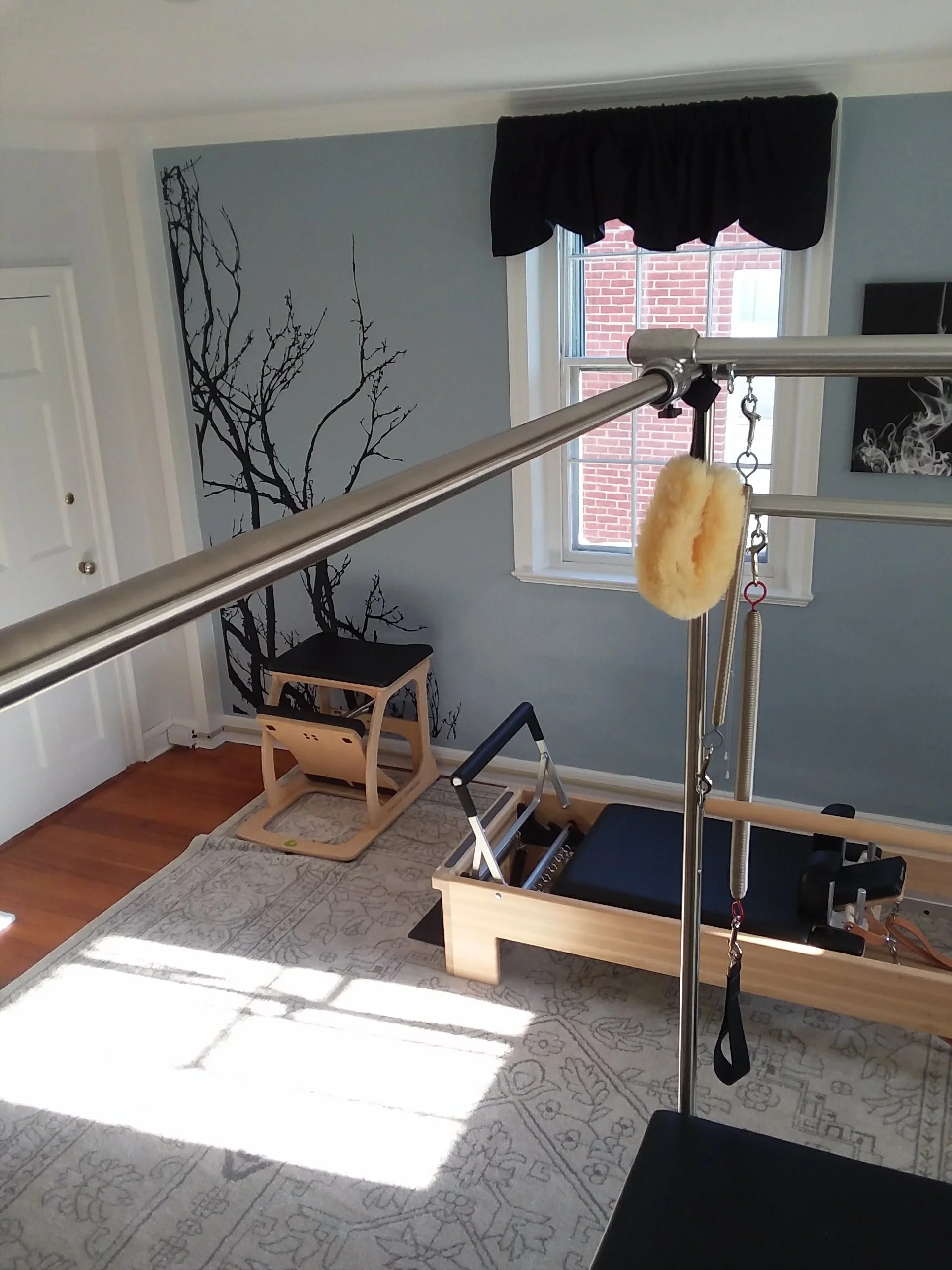 Inside the Redefined studio with tower, reformer and chair